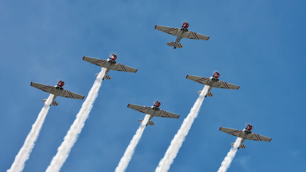 Geico Skytyper flyover with smoke trails